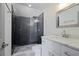 Modern bathroom with a glass door shower, dark tile, and marble vanity at 4085 Amberly Nw Grn, Kennesaw, GA 30144