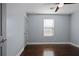 A clean, bright bedroom featuring hardwood floors and a ceiling fan at 4085 Amberly Nw Grn, Kennesaw, GA 30144