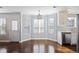 Bright dining area features hardwood floors, large windows, and stainless steel dishwasher and sink at 4085 Amberly Nw Grn, Kennesaw, GA 30144