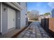 Side view of a gray house with a white front door and a stone paver driveway at 4085 Amberly Nw Grn, Kennesaw, GA 30144