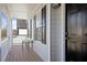 Inviting front porch with wood flooring and white pillars, leading to the front door at 4085 Amberly Nw Grn, Kennesaw, GA 30144
