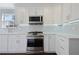 Updated kitchen boasts stainless steel oven, white cabinets, white countertops, and stainless steel microwave at 4085 Amberly Nw Grn, Kennesaw, GA 30144