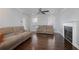 Bright living room with a fireplace and ample seating, showcasing hardwood floors at 4085 Amberly Nw Grn, Kennesaw, GA 30144