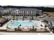 Aerial view of the community featuring a large pool, apartment buildings, and well-manicured landscaping at 704 Dodd Ln # 158, Buford, GA 30518