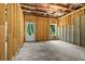 Unfinished basement featuring wooden framing, concrete floor, and natural light at 704 Dodd Ln # 158, Buford, GA 30518