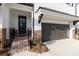 New townhome with white brick, black door and a attached garages at 704 Dodd Ln # 158, Buford, GA 30518