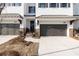New townhome with white brick, black door and a attached garages at 704 Dodd Ln # 158, Buford, GA 30518