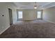 Large main bedroom featuring neutral walls and carpet, ceiling fan, and tray ceiling at 7330 Taloga Ln, Union City, GA 30291