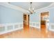 Bright dining room with hardwood floors, decorative molding, and modern chandelier lighting at 215 Aldridge Pl # 9, Smyrna, GA 30082