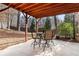 Outdoor patio features stained wood ceiling, concrete flooring, and outdoor seating at 6304 Long Island Drive, Sandy Springs, GA 30328