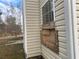 Close up of house siding and boarded up window at 6357 Polar Fox Ct, Riverdale, GA 30296