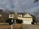 Inviting two-story home featuring a well-manicured lawn and an attached two-car garage at 6357 Polar Fox Ct, Riverdale, GA 30296