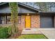 Charming single-story home with a brick facade, a yellow front door, and attached garage at 2867 Dresden Way, Atlanta, GA 30341