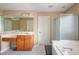 Bathroom featuring a soaking tub, shower, and a spacious vanity area at 3008 Stockbridge Way, Dacula, GA 30019
