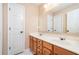Bathroom featuring double sinks, wooden cabinets, and a large mirror at 3008 Stockbridge Way, Dacula, GA 30019