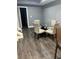 Dining area with a glass table, four upholstered chairs, and wood-look tile flooring at 3008 Stockbridge Way, Dacula, GA 30019