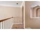 Neutral-toned hallway with arched accents and wood-trimmed railings at 3008 Stockbridge Way, Dacula, GA 30019