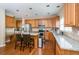 Well-lit kitchen featuring a granite countertop, ample wood cabinetry, and recessed lighting at 3008 Stockbridge Way, Dacula, GA 30019