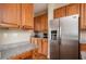 Well-equipped kitchen with stainless steel refrigerator and granite countertops at 3008 Stockbridge Way, Dacula, GA 30019