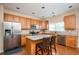 Bright kitchen featuring a center island, stainless steel appliances, and wood floors at 3008 Stockbridge Way, Dacula, GA 30019