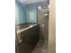 Modern shower with gray tiling, glass door, and built-in shower caddy at 3008 Stockbridge Way, Dacula, GA 30019