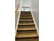 Carpeted stairs leading to the upper level of the home at 3008 Stockbridge Way, Dacula, GA 30019