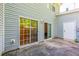 Backyard patio featuring two sliding glass doors leading into the home and a white door leading into a storage room at 485 Lantern Wood Dr, Scottdale, GA 30079