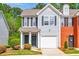 Charming two-story home with a well-maintained lawn and attached garage at 485 Lantern Wood Dr, Scottdale, GA 30079