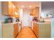 Efficient kitchen layout with wood cabinets and white appliances at 485 Lantern Wood Dr, Scottdale, GA 30079