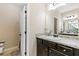 Bathroom with a mirror, vanity, and a toilet with tiled floors at 11181 Wind Ridge Dr, Hampton, GA 30228