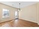 Spacious dining area with plenty of natural light, access to the exterior and hardwood flooring at 11181 Wind Ridge Dr, Hampton, GA 30228