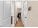 Hallway with hardwood floors, white doors and access to multiple rooms at 11181 Wind Ridge Dr, Hampton, GA 30228