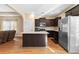 Well-lit kitchen features dark cabinetry, granite countertops and stainless steel appliances at 11181 Wind Ridge Dr, Hampton, GA 30228