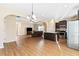 Open-concept living room features laminate flooring, modern fixtures, and seamless flow into the kitchen at 11181 Wind Ridge Dr, Hampton, GA 30228