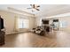 Open-concept living room features laminate flooring, modern fixtures, and seamless flow into the kitchen at 11181 Wind Ridge Dr, Hampton, GA 30228