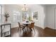 Inviting dining room with modern lighting and a stylish table set, surrounded by windows and hardwood floors at 1612 Alder Se Ct, Atlanta, GA 30317