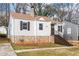 Charming bungalow-style home featuring stone foundation, white siding, and mature trees in a desirable neighborhood at 1612 Alder Se Ct, Atlanta, GA 30317