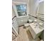 Cozy bathroom featuring a toilet and single sink vanity with chrome hardware and a framed mirror at 1905 Fort Valley Sw Dr, Atlanta, GA 30311