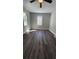 A well-lit room is painted light gray and is floored with new gray-brown vinyl plank flooring at 2322 Ewing Sw St, Atlanta, GA 30331