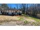 A quaint white home with black trim on a lot with sparse grass at 2322 Ewing Sw St, Atlanta, GA 30331