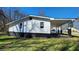 White sided house with a covered patio, complemented by a neat, green lawn at 2322 Ewing Sw St, Atlanta, GA 30331