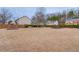 Expansive back yard featuring mature trees, partial privacy fence and a sitting bench at 243 Wedmore Ct, Suwanee, GA 30024