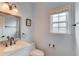 This is a bathroom with a large mirror, toilet, and window at 243 Wedmore Ct, Suwanee, GA 30024