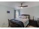 Bedroom features a ceiling fan, carpet, a window, and black wood furniture at 243 Wedmore Ct, Suwanee, GA 30024