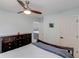 Bedroom featuring a ceiling fan, carpet, dark wood dresser and trim at 243 Wedmore Ct, Suwanee, GA 30024