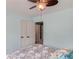 Bedroom featuring blue walls, carpet, a ceiling fan and double closets with white doors at 243 Wedmore Ct, Suwanee, GA 30024