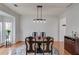 Dining room showcasing modern light fixtures, a round table, and classic decor at 243 Wedmore Ct, Suwanee, GA 30024