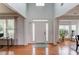 Bright foyer featuring hardwood floors, large windows, and neutral paint at 243 Wedmore Ct, Suwanee, GA 30024