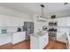 Well-lit kitchen with stainless steel appliances, marble backsplash, and a central island at 243 Wedmore Ct, Suwanee, GA 30024