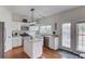 Bright kitchen with white cabinets, stainless steel appliances, and a center island at 243 Wedmore Ct, Suwanee, GA 30024